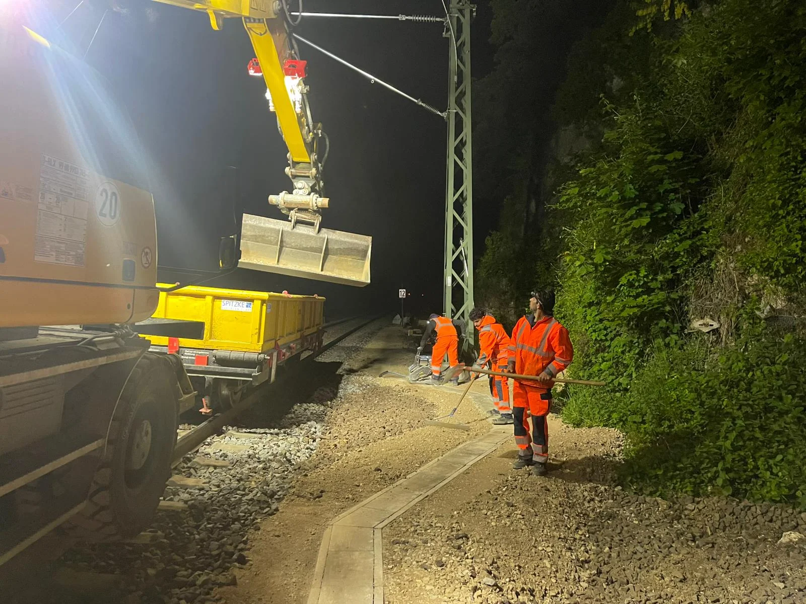Railway construction crew working alongside the track at night